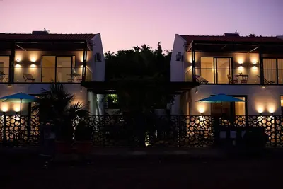 a night view of a building with lights at CORAL BAY - Kode Villa in Cidade Velha