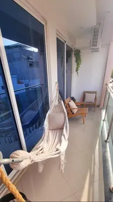 a hammock on the balcony of a house at Palmarejo Center Apartment Suites in Praia