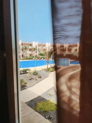 a view of a pool from the door of a house at HostySpot - Tropical Resort in Santa Maria