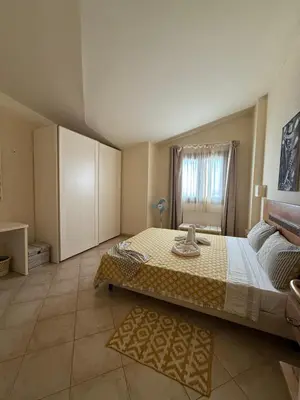 a bedroom with a large bed and a window at HostySpot - Tropical Resort in Santa Maria