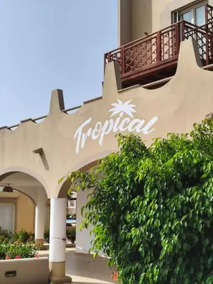 a hotel sign on the side of a building at HostySpot - Tropical Resort in Santa Maria
