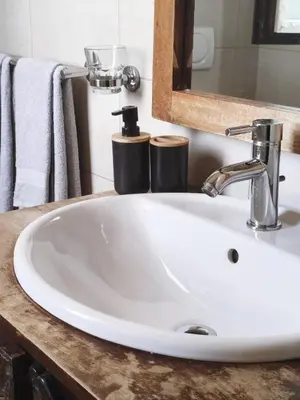 a white sink in a bathroom with a mirror at HostySpot - Tropical Resort in Santa Maria