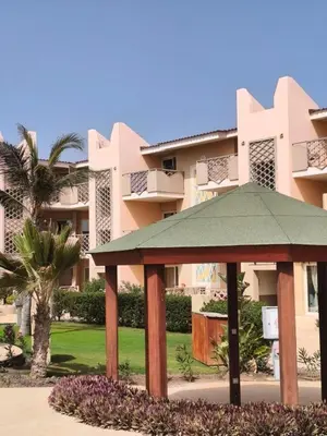 a gazebo in front of a large building at HostySpot - Tropical Resort in Santa Maria