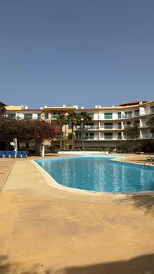 a large swimming pool in front of a building at HostySpot - Vila Verde Resort in Santa Maria