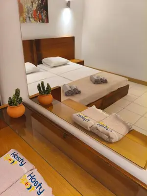 a bedroom with two beds with towels on a counter at HostySpot - Vila Verde Resort in Santa Maria