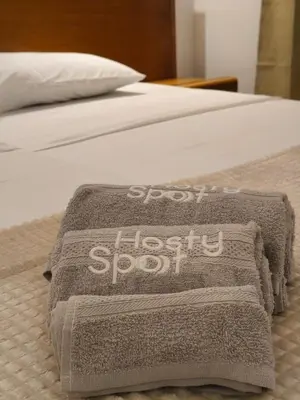 a bed with a blanket on it with the words notley soft at HostySpot - Vila Verde Resort in Santa Maria