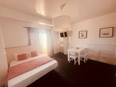a bedroom with a bed and a table and a window at Casa Relaxa in Sal Rei
