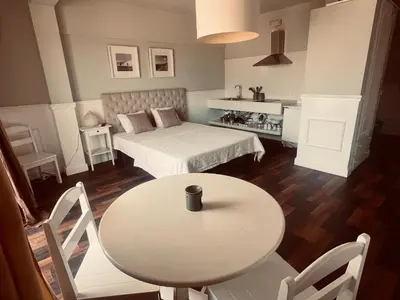 a room with a table and a bed and a table and chairs at Casa Relaxa in Sal Rei