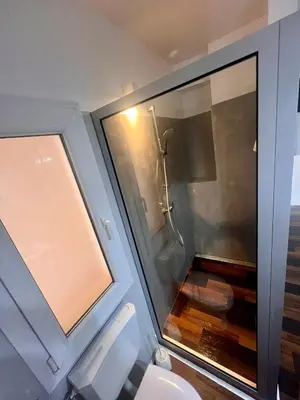 a bathroom with a toilet and a glass shower at Casa Relaxa in Sal Rei