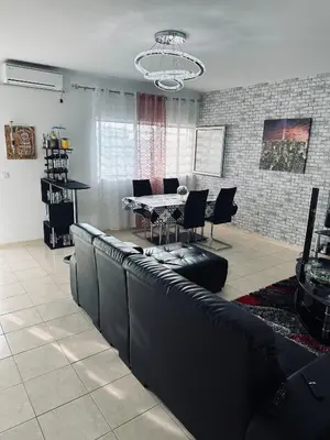 a living room with a dining table and chairs at Condominio Finaçon praia ilha santiago in Prainha