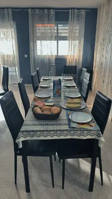a dining room table with plates and food on it at Pensao Restaurante Recanto in Tarrafal