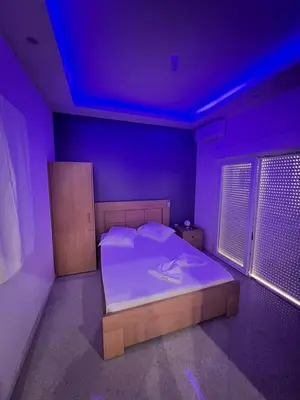 a bedroom with a bed with a purple ceiling at Pensao Restaurante Recanto in Tarrafal