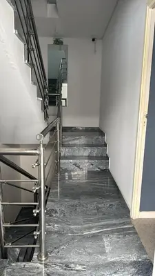 a staircase in a building with a metal railing at Pensao Restaurante Recanto in Tarrafal