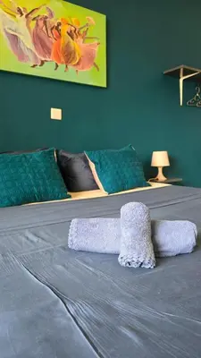 a bedroom with a bed with a blanket on it at Celina's Cozy Studio & Beach Life in One in Santa Maria