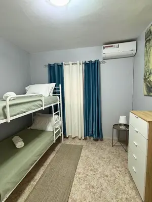 a bedroom with two bunk beds and a window at Doce de Sal in Santa Maria