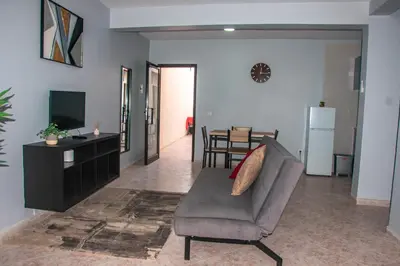 a living room with a couch and a television at Doce de Sal in Santa Maria