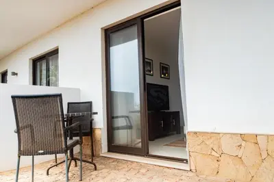 a room with sliding glass doors and a chair at HostySpot - Melia Dunas in Santa Maria