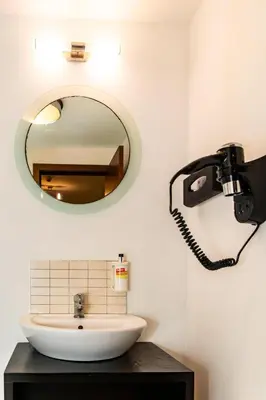 a bathroom with a mirror and a sink at HostySpot - Melia Dunas in Santa Maria