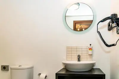 a bathroom with a sink and a mirror at HostySpot - Melia Dunas in Santa Maria