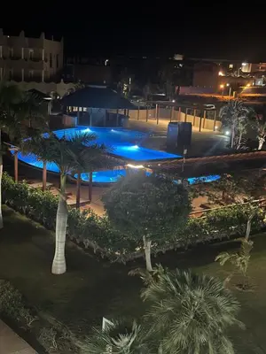 a swimming pool at night with blue lights at Tropical Mediterraneo in Santa Maria