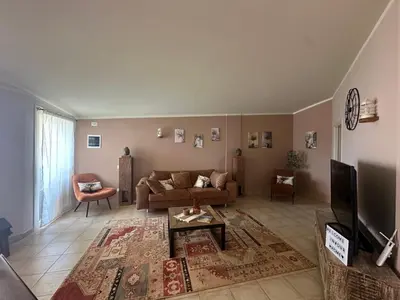 a living room with a couch and a tv at Tropical Mediterraneo in Santa Maria