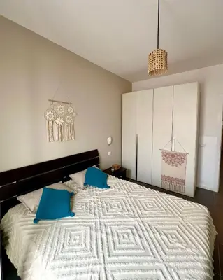 a bedroom with a large bed with blue pillows at Surfing Ocean View Appartment in Sal Rei