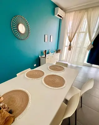 a kitchen with a white table with chairs and a mirror at Surfing Ocean View Appartment in Sal Rei