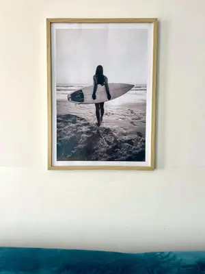 a picture of a person holding a surfboard on a wall at Surfing Ocean View Appartment in Sal Rei