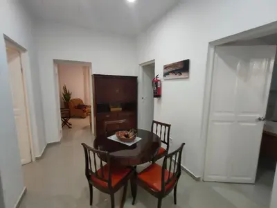 a dining room with a table and four chairs at Vivenda Paraíso, Charming house on the Plateau in Praia