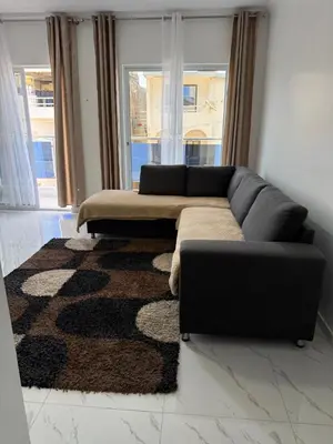 a living room with a couch and a rug at Appartement Praia Sao Felipe in Praia