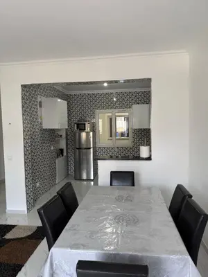a dining room with a table and chairs and a mirror at Appartement Praia Sao Felipe in Praia