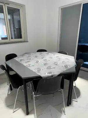 a black table with chairs around it in a room at Appartement Praia Sao Felipe in Praia
