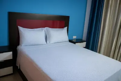 a bedroom with a white bed with a red headboard at Cantinho dos Dias in Espargos