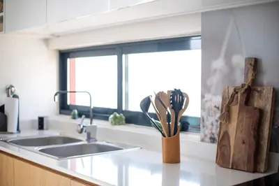 a kitchen counter with a sink and a knife block at Suncent apartment in Mindelo