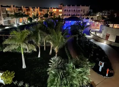 an aerial view of a resort at night with palm trees at Tropical Resort Pool View - Apartment in Santa Maria