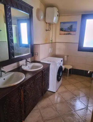 a bathroom with two sinks and a washing machine at Tropical Resort Pool View - Apartment in Santa Maria