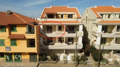 a red circle on the side of a building at Miguel House in Santa Maria
