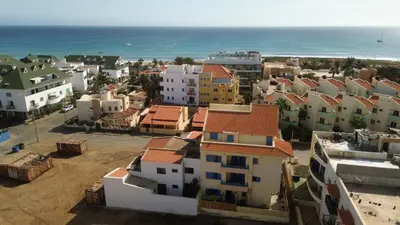 an aerial view of a city with houses and the ocean at Miguel House in Santa Maria