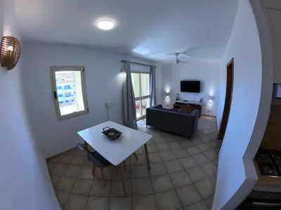 a living room with a table and a couch at Miguel House in Santa Maria