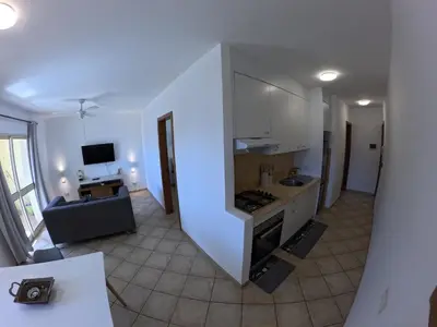 a kitchen with a staircase leading to a living room at Miguel House in Santa Maria