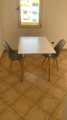 a white table and two chairs in a room at Miguel House in Santa Maria