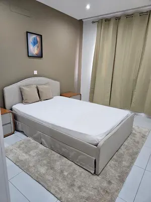 a bedroom with a large bed with white sheets at T3 Duplex - Palmarejo Grande in Praia