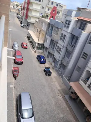 a group of cars parked on a street next to buildings at Boavista Estoril Residence Sol & Mar in Sal Rei