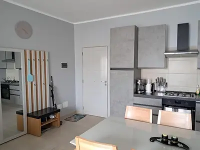 a large white kitchen with a table and chairs at Boavista Estoril Residence Sol & Mar in Sal Rei