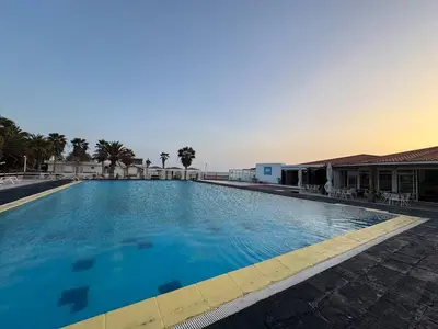 a large swimming pool with blue water at Murdeira V17 RC by RPG Group in Beirona