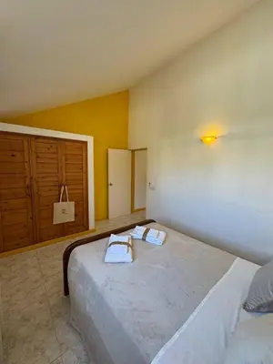 a bedroom with a large bed with towels on it at Murdeira V31 G by RPG Group in Beirona