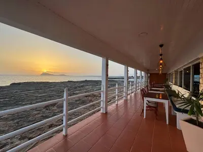 a balcony with a table and chairs on the beach at Murdeira V31 G by RPG Group in Beirona