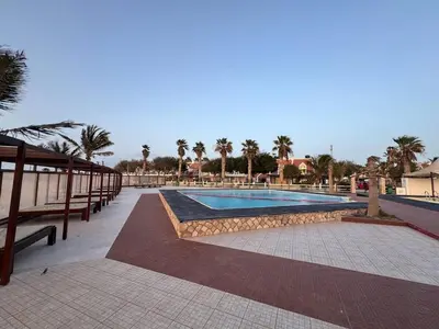 a swimming pool in a resort with palm trees at Murdeira V31 G by RPG Group in Beirona