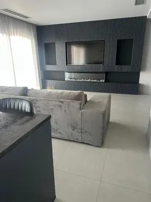 a living room with a couch and a flat screen tv at Boa Vista Apartment in Prainha