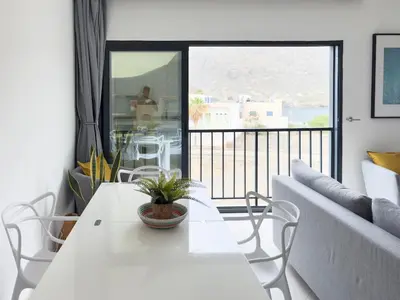 a living room with a white table and a couch at Cozy apt amazing seaview - 2 min from beach - LCGR in Tarrafal